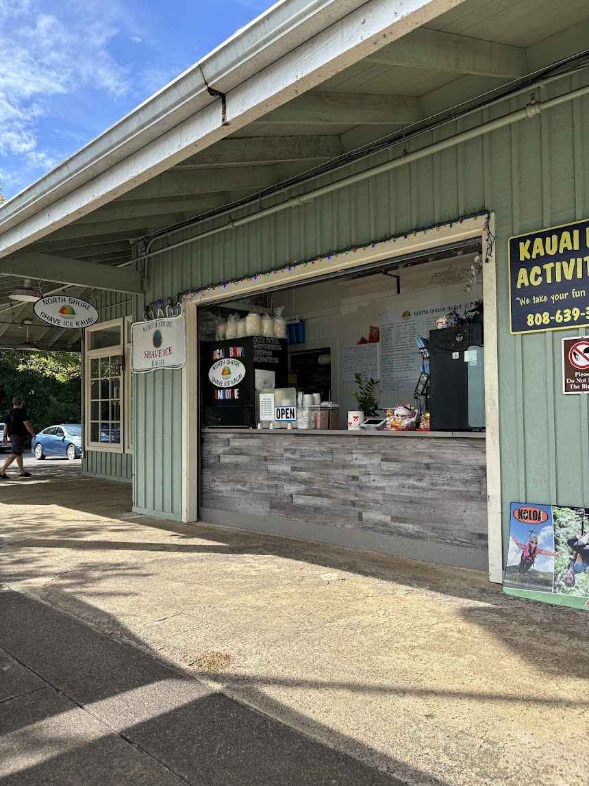 Shop window and Kauai Activities sign under a blue sky